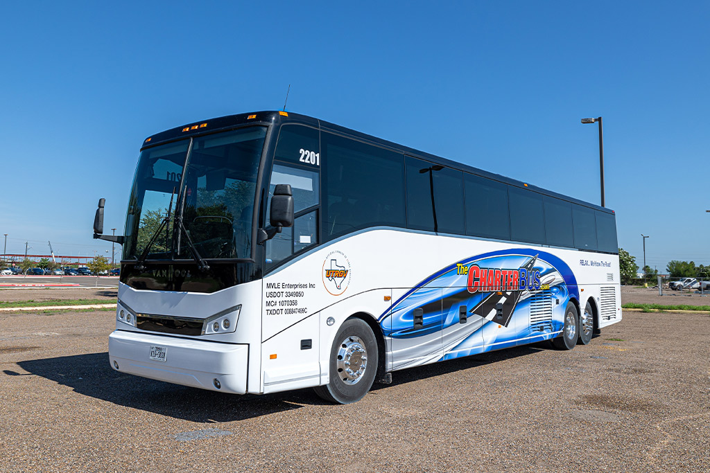 Charter Bus RGVTours in McAllen and South Texas. A white bus parked in a lot, highlighting charter bus rental prices across various Texas cities. 