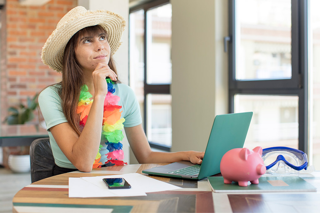 A woman in a hat holds a laptop, ready to share travel tips for families exploring the RGV together.