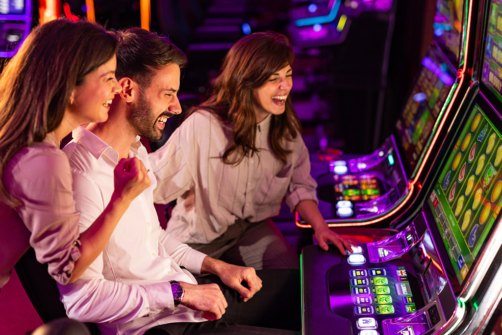An assortment of casino games featuring colorful slot machines, poker chips, and roulette wheels in a lively gaming environment.