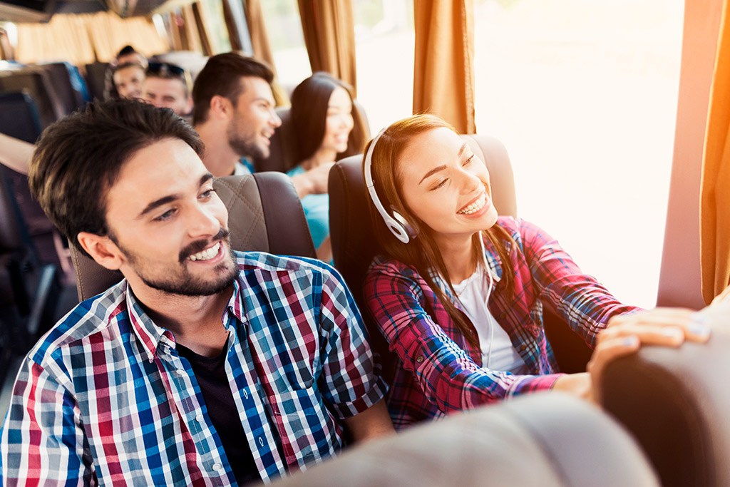 A group of people wearing headphones on a bus, enjoying a casino trip together.